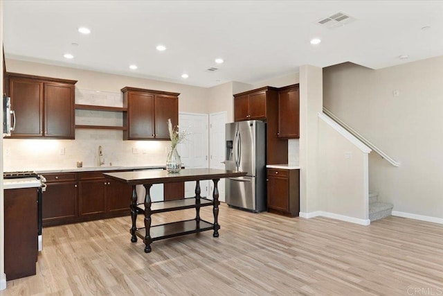 1514 Crown Ln Unit 1, Chula Vista, CA 91915 - kitchen with appliances with stainless steel finishes, light wood-type flooring, light countertops, decorative backsplash, and recessed lighting