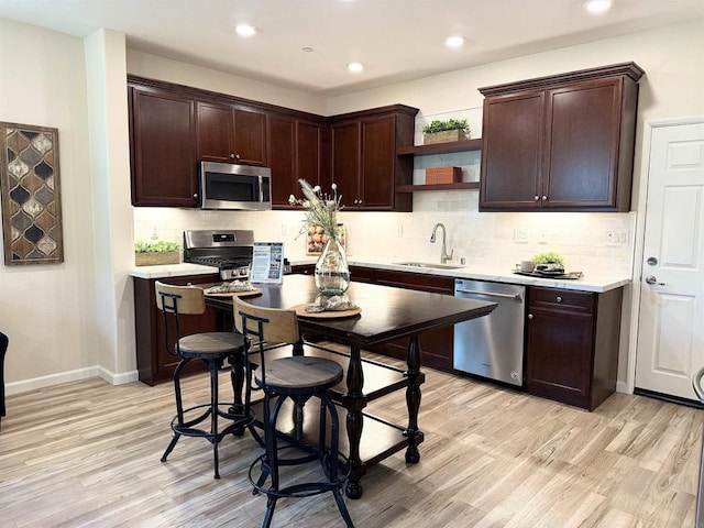 1514 Crown Ln Unit 1, Chula Vista, CA 91915 - kitchen with stainless steel appliances, light wood-type flooring, open shelves, dark brown cabinetry, and recessed lighting