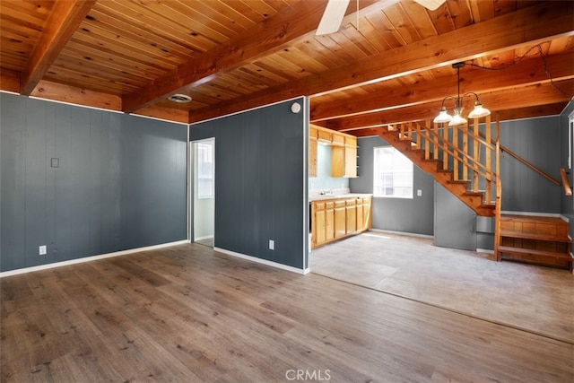 441 Sunset Ln, Sugarloaf, CA 92386 - unfurnished living room with wood finished floors, beamed ceiling, stairway, baseboards, and wooden ceiling