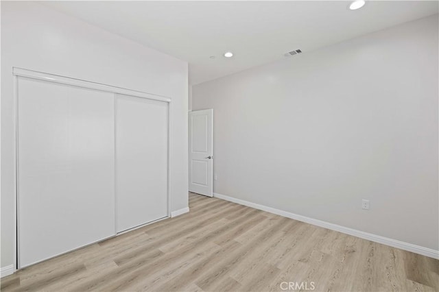 40729 171th, Lake Los Angeles, CA 93535 - unfurnished bedroom featuring light wood-type flooring, a closet, recessed lighting, and baseboards