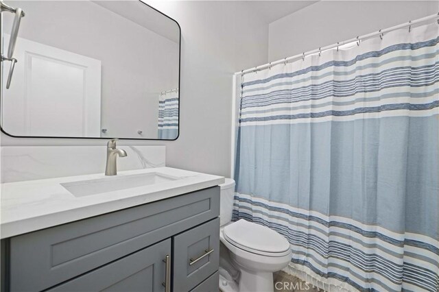 40729 171th, Lake Los Angeles, CA 93535 - bathroom with toilet, vanity, and a shower with shower curtain