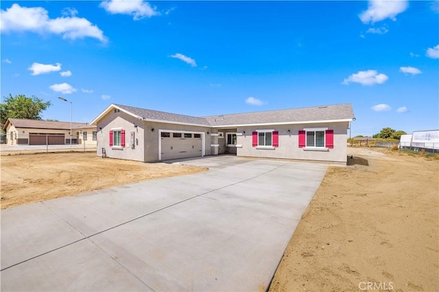 40729 171th, Lake Los Angeles, CA 93535 - single story home featuring a garage, driveway, stucco siding, and fence
