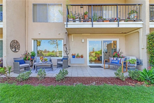 3364 Punta Alta Unit 1E, Laguna Woods, CA 92637 - back of house featuring a balcony, stucco siding, outdoor lounge area, and a patio