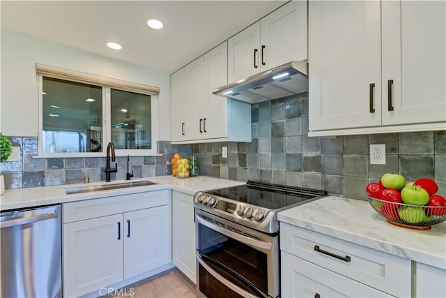 3364 Punta Alta Unit 1E, Laguna Woods, CA 92637 - kitchen with appliances with stainless steel finishes, a sink, under cabinet range hood, white cabinets, and recessed lighting
