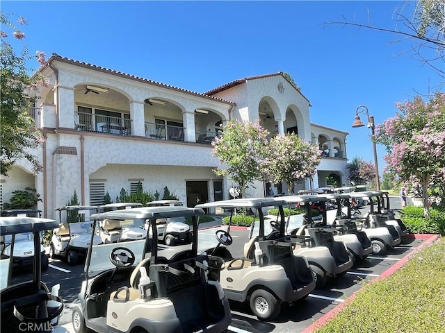 3364 Punta Alta Unit 1E, Laguna Woods, CA 92637 - view of front of property featuring stucco siding, a tiled roof, a balcony, and parking