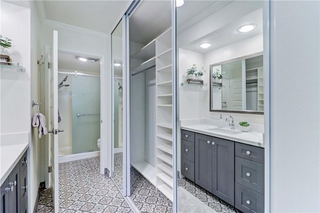 3364 Punta Alta Unit 1E, Laguna Woods, CA 92637 - full bathroom featuring ornamental molding, vanity, a walk in closet, toilet, and recessed lighting