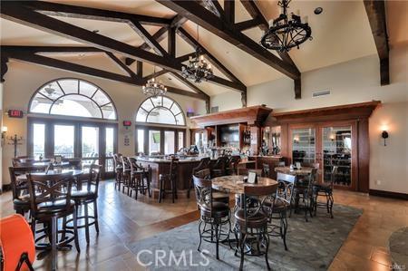 3364 Punta Alta Unit 1E, Laguna Woods, CA 92637 - dining room with a chandelier, beamed ceiling, high vaulted ceiling, and french doors