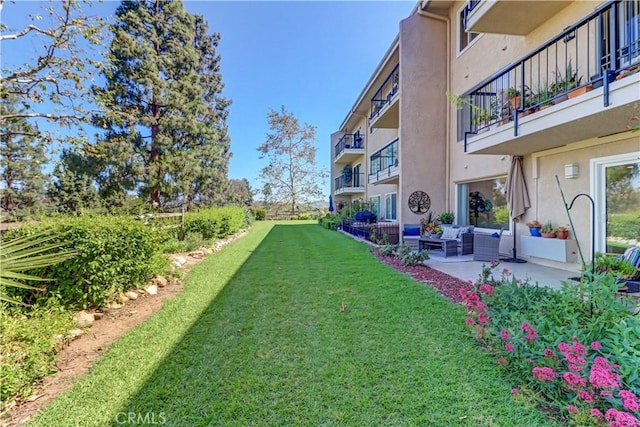 3364 Punta Alta Unit 1E, Laguna Woods, CA 92637 - view of green lawn with a balcony, a patio, and outdoor lounge area