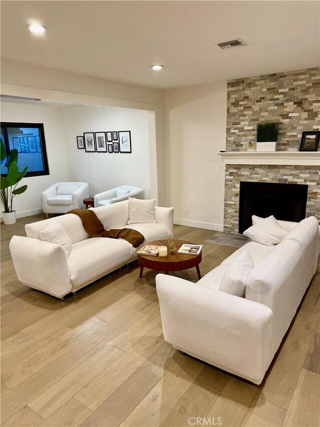 17037 Covello St, Van Nuys, CA 91406 - living room with wood finished floors, a large fireplace, baseboards, and recessed lighting