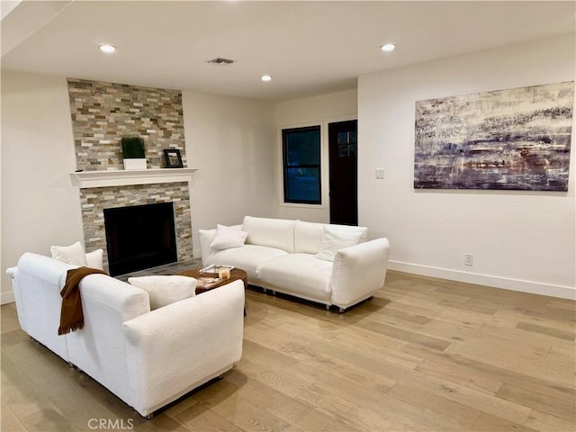 17037 Covello St, Van Nuys, CA 91406 - living area with light wood-style floors, baseboards, recessed lighting, and a fireplace