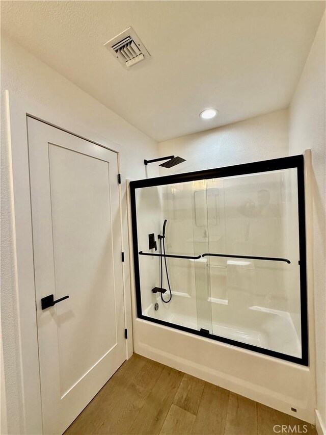 17037 Covello St, Van Nuys, CA 91406 - bathroom with wood finished floors, bath / shower combo with glass door, and recessed lighting