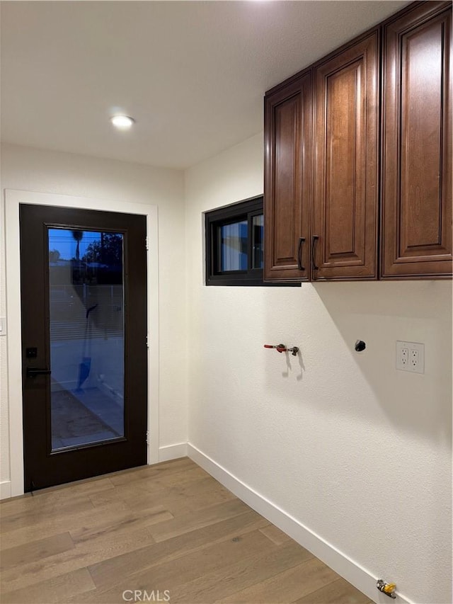17037 Covello St, Van Nuys, CA 91406 - laundry room with baseboards, cabinet space, light wood finished floors, and recessed lighting