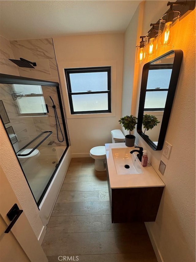 17037 Covello St, Van Nuys, CA 91406 - full bathroom featuring toilet, a shower with shower door, hardwood / wood-style flooring, vanity, and baseboards