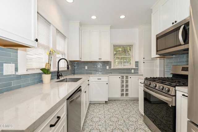 1540 Whitefield Rd, Pasadena, CA 91104 - kitchen with stainless steel appliances, a sink, tasteful backsplash, white cabinetry, and recessed lighting