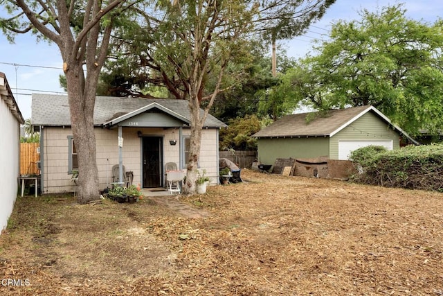 1540 Whitefield Rd, Pasadena, CA 91104 - view of front of house with a detached garage, roof with shingles, fence, and an outbuilding
