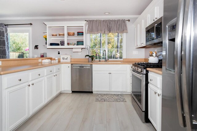 797 Trailside Pl, San Marcos, CA 92078 - kitchen featuring appliances with stainless steel finishes, ornamental molding, light countertops, white cabinetry, and open shelves