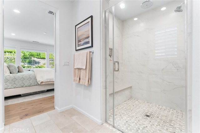 bathroom featuring ensuite bathroom, a stall shower, baseboards, recessed lighting, and tile patterned flooring