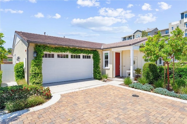 view of front of property with driveway, a garage, and stucco siding