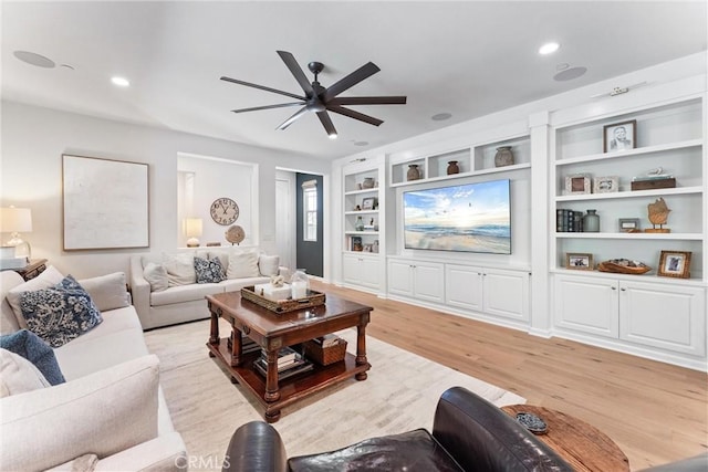 living area featuring a ceiling fan, light wood finished floors, built in features, and recessed lighting