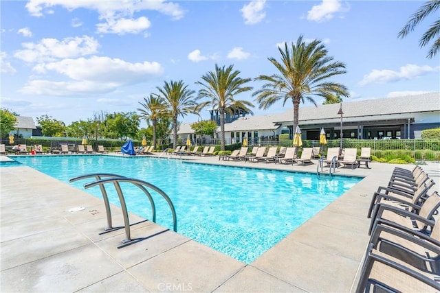 community pool featuring fence and a patio area
