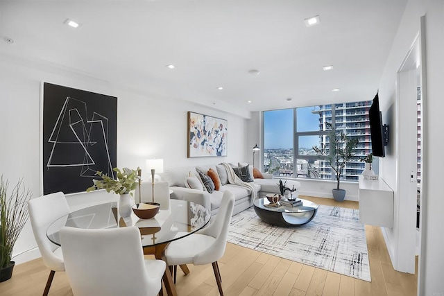 dining area featuring light wood-style flooring, recessed lighting, and baseboards