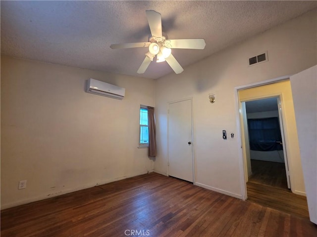 10141 Brockway St, El Monte, CA 91733 - unfurnished bedroom featuring a wall mounted air conditioner, wood finished floors, a textured ceiling, baseboards, and a ceiling fan