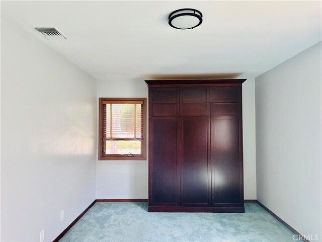 6149 Whitewood Ave, Lakewood, CA 90712 - unfurnished bedroom featuring light colored carpet, baseboards, and a closet
