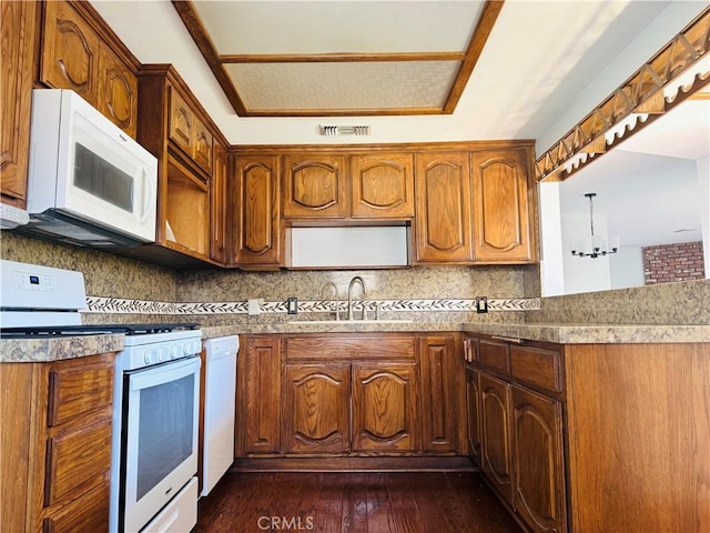 6149 Whitewood Ave, Lakewood, CA 90712 - kitchen featuring white appliances, a sink, decorative backsplash, dark wood-type flooring, and brown cabinetry