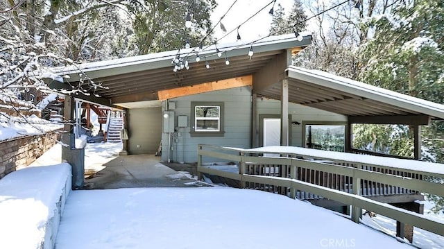 view of front of home with a deck and an attached carport