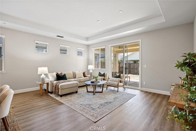 3445 Chamberlain Run, Chico, CA 95973 - living room featuring a raised ceiling, baseboards, wood finished floors, and plenty of natural light