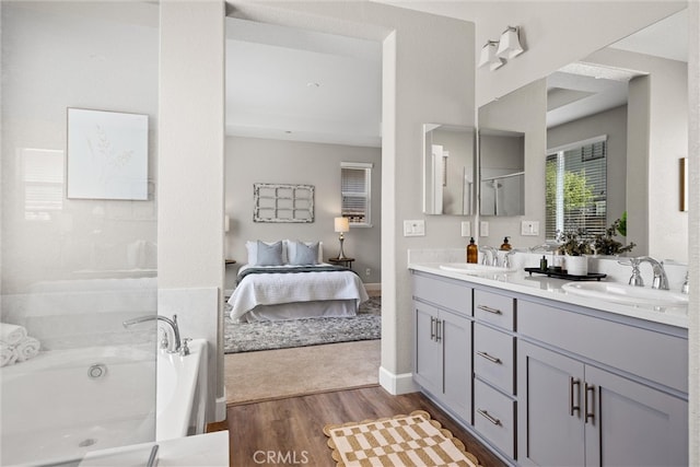 3445 Chamberlain Run, Chico, CA 95973 - bathroom featuring ensuite bath, a tub to relax in, double vanity, wood finished floors, and a shower