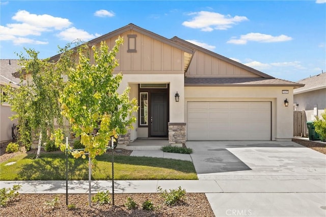 3445 Chamberlain Run, Chico, CA 95973 - view of front of property featuring board and batten siding, concrete driveway, an attached garage, stone siding, and stucco siding