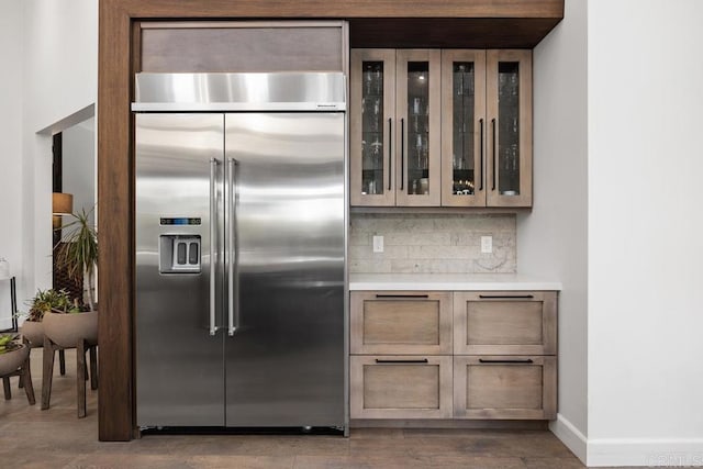 1240 Berryman Cyn, Encinitas, CA 92024 - kitchen with stainless steel built in refrigerator, tasteful backsplash, light countertops, glass insert cabinets, and dark wood-style floors