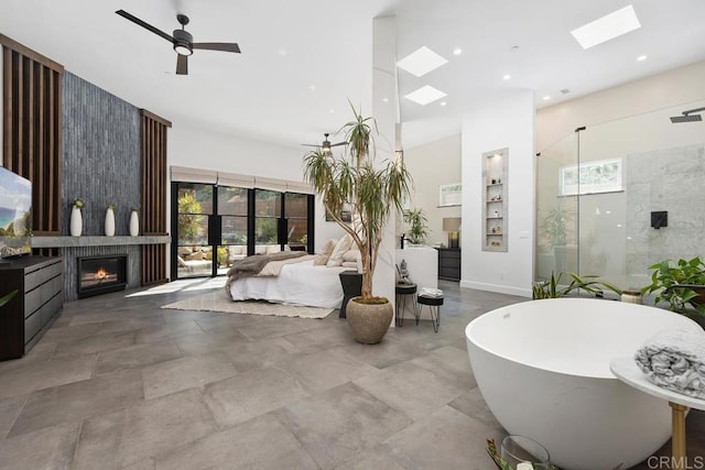 1240 Berryman Cyn, Encinitas, CA 92024 - bedroom featuring a skylight, a towering ceiling, multiple windows, and a large fireplace