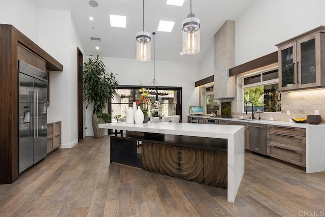 1240 Berryman Cyn, Encinitas, CA 92024 - kitchen featuring stainless steel appliances, light countertops, high vaulted ceiling, a sink, and a skylight