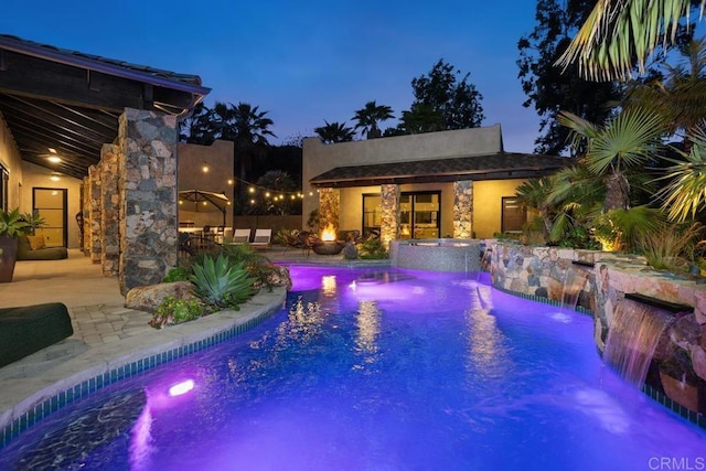 1240 Berryman Cyn, Encinitas, CA 92024 - pool at twilight featuring a storage structure, a patio area, an outbuilding, and a pool with connected hot tub