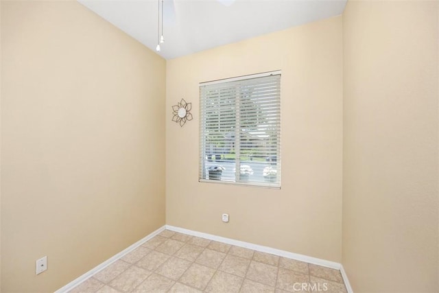 empty room with baseboards and a ceiling fan