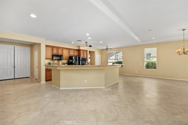 kitchen featuring black appliances, a chandelier, recessed lighting, brown cabinetry, and an island with sink