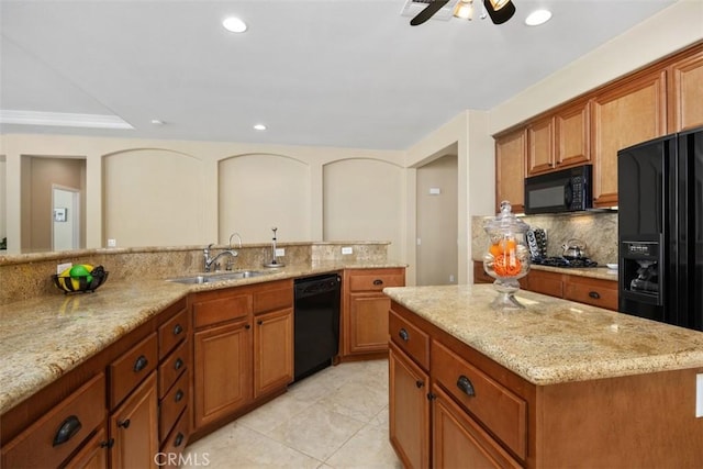 kitchen with black appliances, a sink, tasteful backsplash, brown cabinets, and recessed lighting