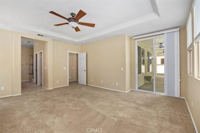 empty room with a ceiling fan, ornamental molding, carpet, and baseboards