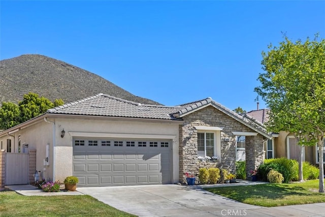 ranch-style house with an attached garage, concrete driveway, stucco siding, and a tile roof