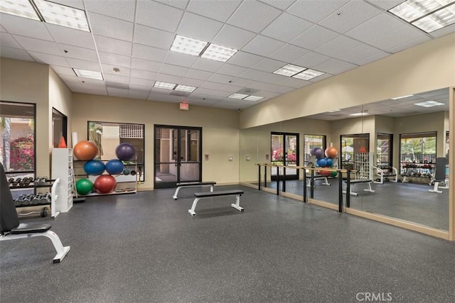 exercise room with a paneled ceiling