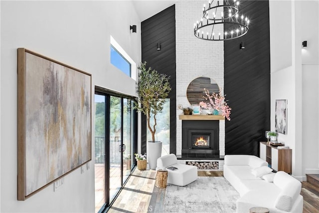 791 Cypress Rd, Lake Arrowhead, CA 92321 - living area with a towering ceiling, a fireplace, wood finished floors, and a chandelier