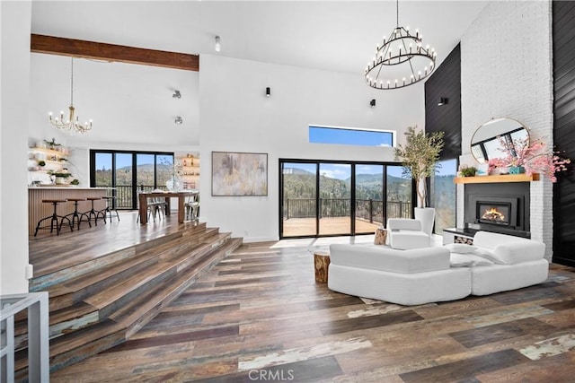 791 Cypress Rd, Lake Arrowhead, CA 92321 - living area featuring a chandelier, a high ceiling, a fireplace, and wood finished floors