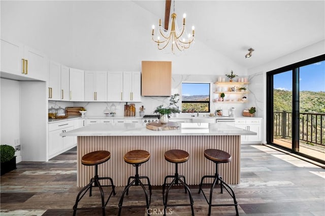 791 Cypress Rd, Lake Arrowhead, CA 92321 - kitchen with high vaulted ceiling, a center island, light countertops, wood finished floors, and tasteful backsplash