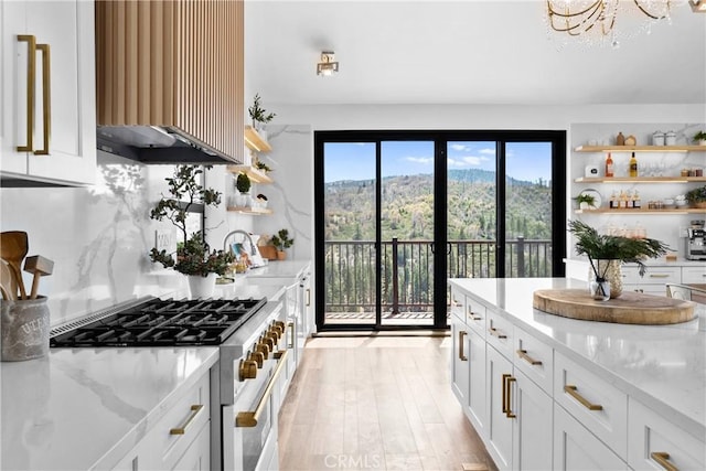 791 Cypress Rd, Lake Arrowhead, CA 92321 - kitchen featuring stainless steel stove, open shelves, decorative backsplash, light stone countertops, and white cabinets