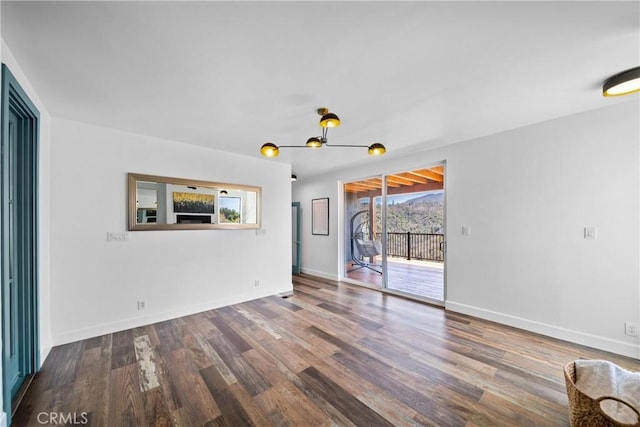 791 Cypress Rd, Lake Arrowhead, CA 92321 - unfurnished living room with wood finished floors, a chandelier, and baseboards