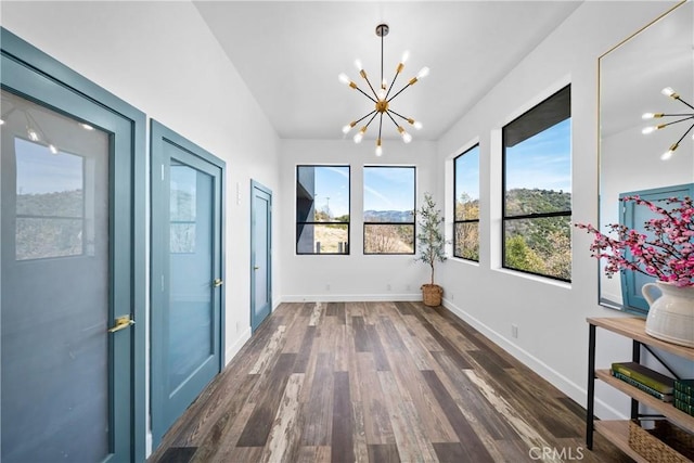 791 Cypress Rd, Lake Arrowhead, CA 92321 - unfurnished dining area featuring a chandelier, dark wood-style floors, and baseboards