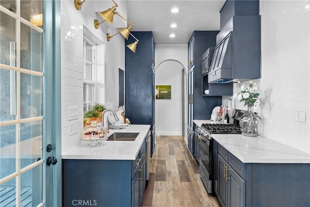 791 Cypress Rd, Lake Arrowhead, CA 92321 - kitchen featuring a sink, gas stove, wood finished floors, light countertops, and baseboards