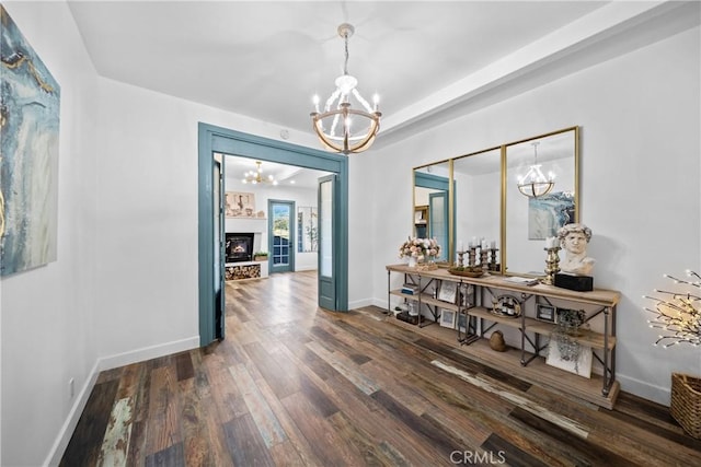 791 Cypress Rd, Lake Arrowhead, CA 92321 - dining room with a chandelier, dark wood finished floors, baseboards, and a warm lit fireplace